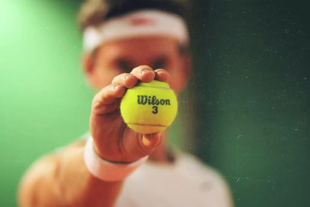 A tennis player with tennis ball