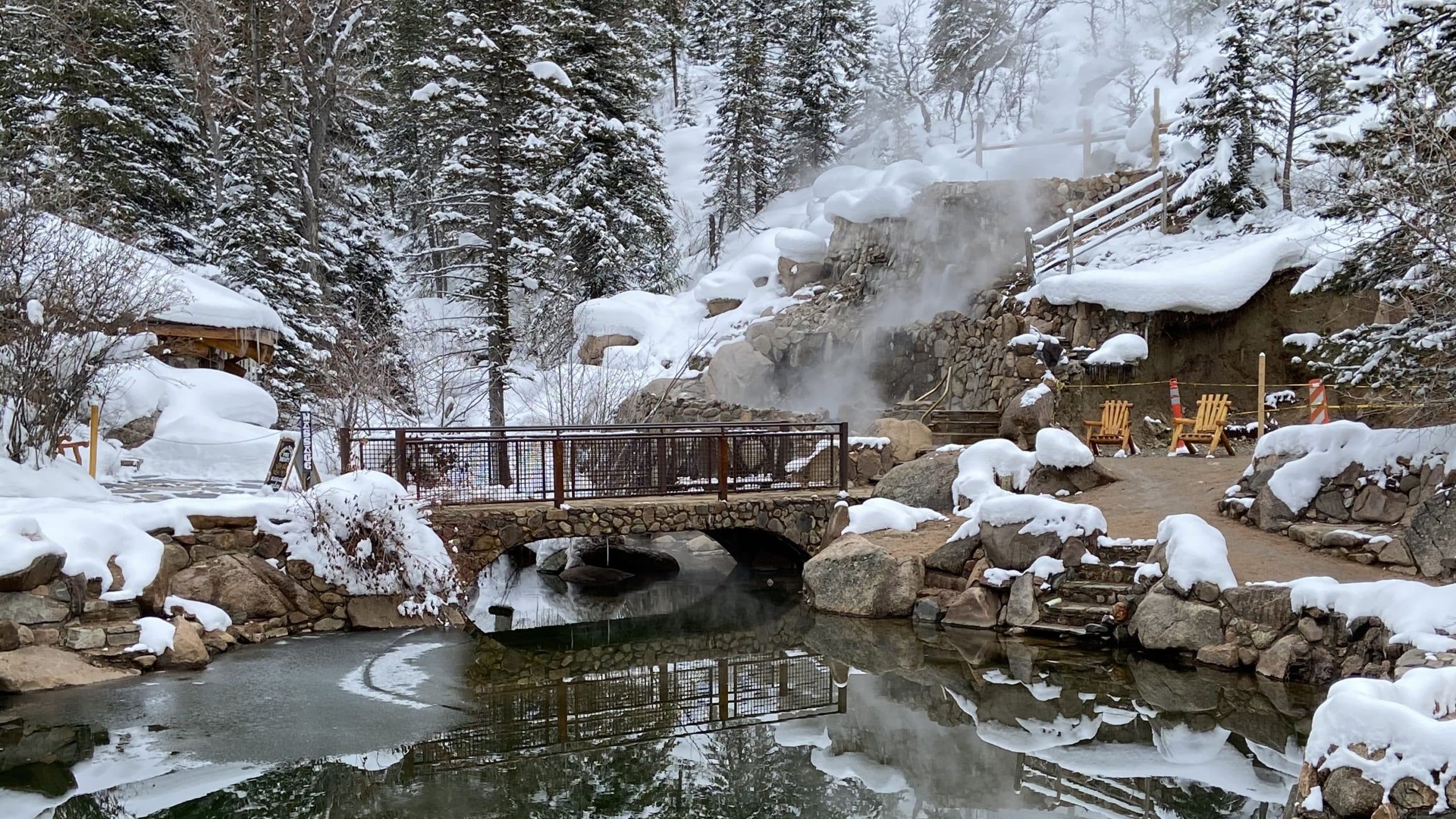 A stone bridge across the icy cold creek leads to the series of hot spring pools. A stone bridge across the icy cold creek leads to the series of hot spring pools.