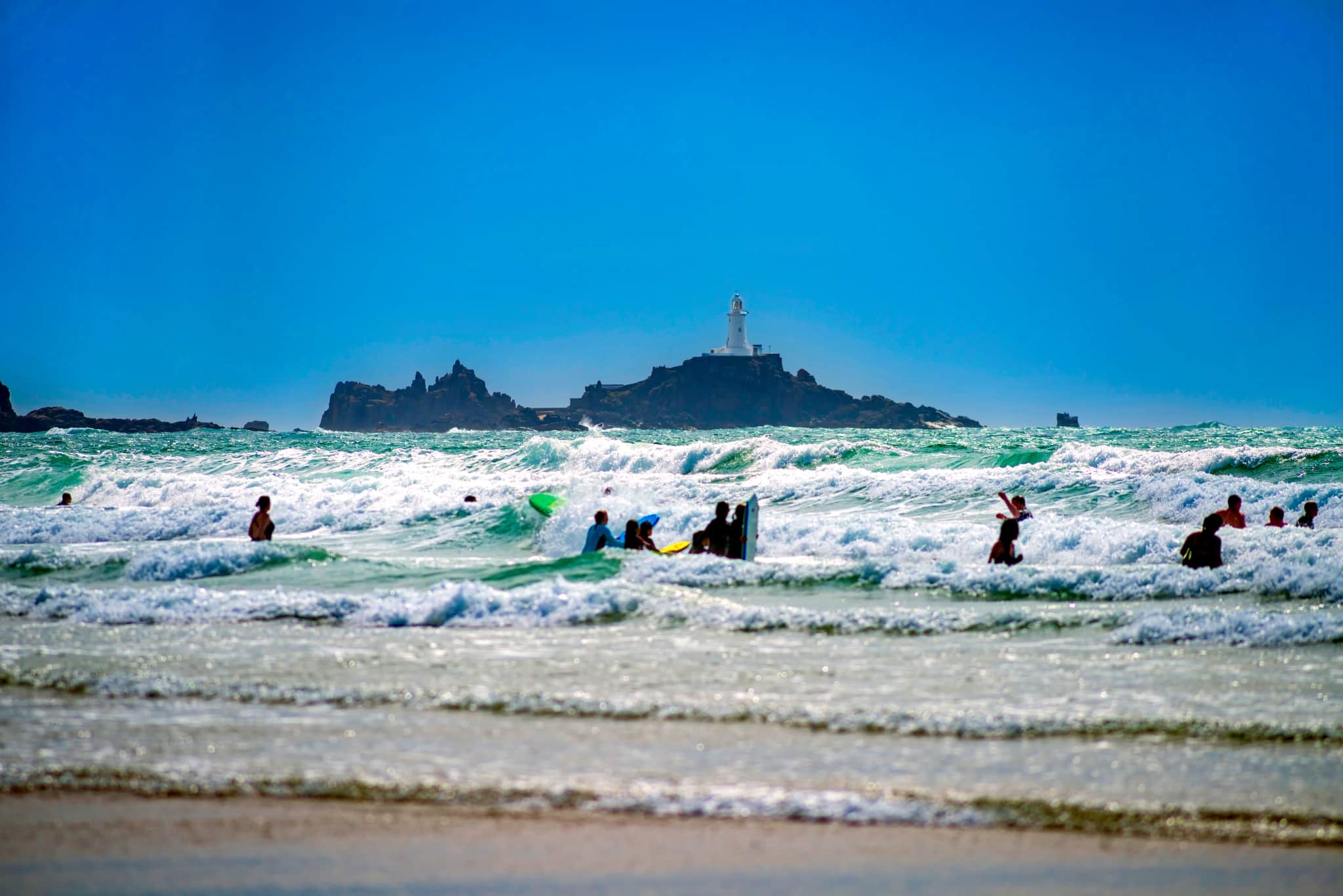 Surfers and swimmers at St Ouen’s Bay